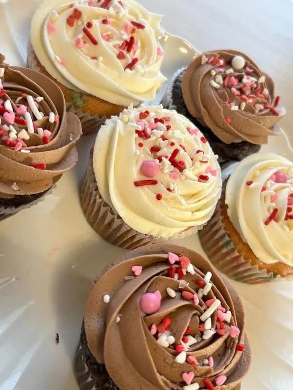 Vanilla and chocolate buttercream cupcakes with pink, red, and white sprinkles